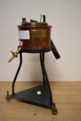 An early 20th century Viscometer supported on a tri-pod base, having brass plaque to side