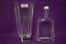 An Orrefors crystal glass vase engraved with a young woman holding a bouquet of flowers,