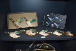 A set of seven early 20th century Keele Street pottery graduated flying duck plaques, hand painted