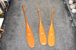 Three vintage pine canoe coracle paddles, longest 107cm.