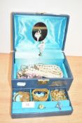 A blue musical jewellery box, containing a small selection of costume jewellery including faux