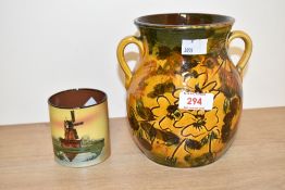 A Long Park Torquay two handled pottery art vase, decorated having flowers and foliage on a yellow