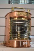 An early 20th century Heklicht copper and brass ships port lantern, having a bow-fronted form with
