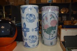 Two vintage ceramic stick stands, hand painted with blue, green and pink foliage on a white glaze