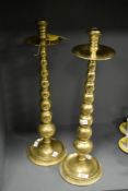 A tall pair of mid-century bobbin stem brass candlesticks, h53cm
