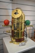 An early 20th century wooden and brass submarine binnacle compass, having to the front a plaque