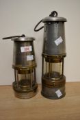 Two Wolf safety Minors lamps by Maurice Ltd, largest H27cm