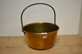 A large early 20th century polished brass jelly pan, having iron handle and rivet nuts, w31cm.