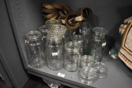 A selection of early 20th Century lidded Kilner jars, including one with embossed lettering and