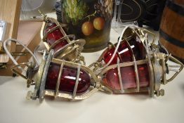 Four early / mid 20th century brass hanging ship lamps having ruby red globes, h30.