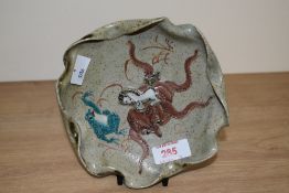 A 20th century Japanese Satsuma pottery plate depicting a white coloured seahorse, brown octopus and