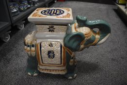 A vintage ceramic elephant garden seat, hand coloured and decorated with traditional Chinese motifs,