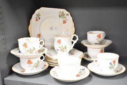 A vintage Pheomix China part tea service, hand coloured in the Art Deco stlye with orange edging and