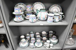 A large group of mid-century Tintagel earthware pottery, decorated with beautifully hand coloured