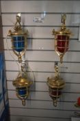 A group of four early 20th century brass ships convoy running lamps, having ruby and turquoise