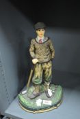 A late 20th century cast iron male golfer door stop, hand coloured, h36cm.