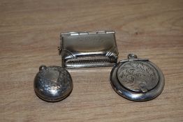 A George V silver sovereign holder, of circular form having floral decoration with a vacant shield