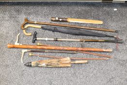 A box containing various walking sticks, to include a swagger stick and Chinese umbrella, (8).