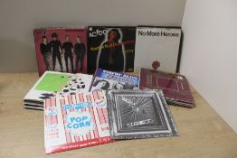 A box of seven inch singles with titles from the Sex Pistols , Stranglers and AC/DC - 55 in