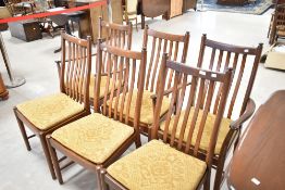 A set of six (four plus two) Ercol rail back dining chairs, medium/dark stained, width upholstered