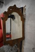A reproduction ornate wall mirror, approx. 106 x 65cm