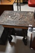 A carved occasional table , having elephant decoration, approx. 54 x 38cm