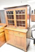 A early 20th Century oak bookcase with drawers and double cupboard to base, width approx. 109cm
