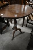 A 19th century mahogany pedestal table having cicrular top on turned column with triple splay