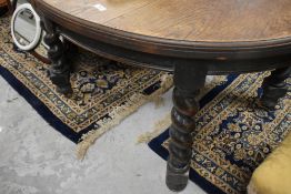 A late 19th or early 20th Century oak oval windout dining table, no winder or centre leaf, on