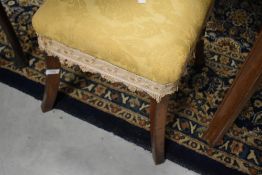 A 19th Century and later upholstered footstool having splay legs