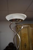 A modern chromed uplighter standard lamp