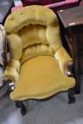 A Victorian button back nursing chair having mahogany knurl frame and gold dralon upholstery