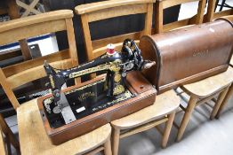 A 19th Century Singer sewing machine, of hand crank design, in oak dome top case