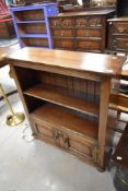 A period oak style low bookshelf with cupboard under, possibly Titchmarsh and Goodwin, width approx.