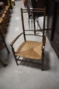A 19th Century carver chair having spindle back and rush seat