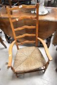 A rush seated ladder back carver chair