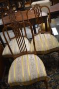 A set of three early 20th Century mahogany salon chairs having overstuffed seats