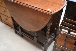 An early to mid 20th Century oak twist gate leg table, width approx. 86cm