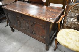A 19th century oak kist having jacobean style panels to front, raised on stile legs, width approx.
