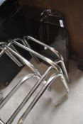 A vintage chrome and smoked glass nest of tables