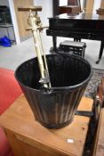 A vintage firebucket and brass hose fittings
