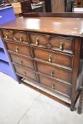 An early 20th Century oak bedroom chest of two over three drawers in the Jacobean style , with