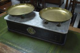 A Victorian French shop balance scale having ebonised case and brass trays over marble base,