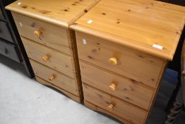 A pair of modern pine three drawer bedside chests of drawers