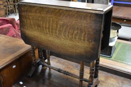 A 19th Century oak sutherland style occasional table having turned gateleg