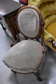 A Victorian button nursing chair having mahogany frame, shield back and beige dralon upholstery