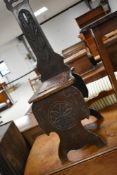 An interesting late 19th or early 20th Century carved hall chair