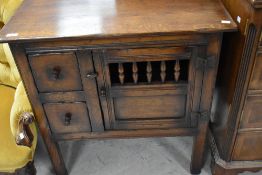 A reproduction oak side cabinet, Titchmarsh and Goodwin or similar, width approx. 77cm