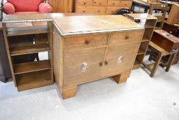 An Art Deco style oak sideboard with bookshelves to each side and pearlescent border detailing