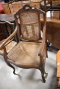 A reproduction canework carver chair